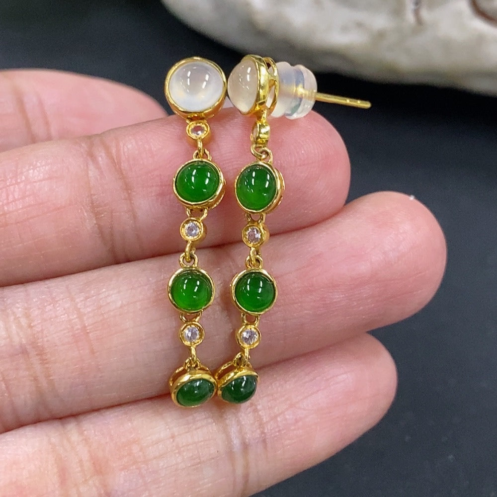 HKHQ jadeite cabochon earrings in 18K gold, showcasing smooth, vibrant green jadeite stones set in elegant gold settings.