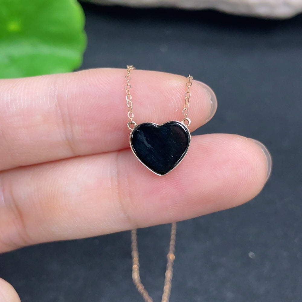 Jadeite heart pendant with inlaid design on an 18k gold chain, weighing approximately 1g, from HKHQ.
