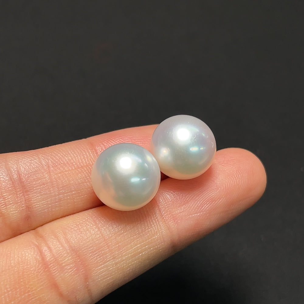 Saltwater pearl earrings with 18K gold setting, featuring elegant pearl dangles on shiny gold posts.