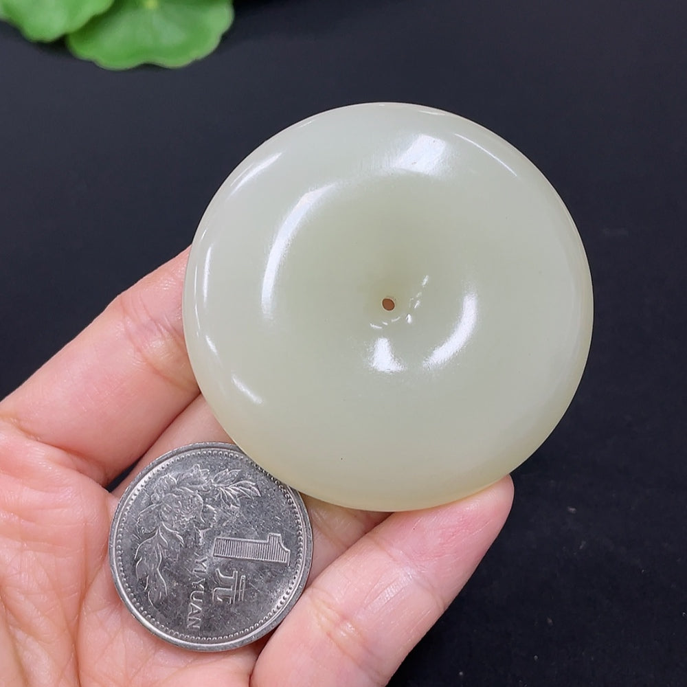 Elegant Hetian jade pendant featuring a peace knot design, crafted by HKHQ, weighing approximately 58.6 grams.