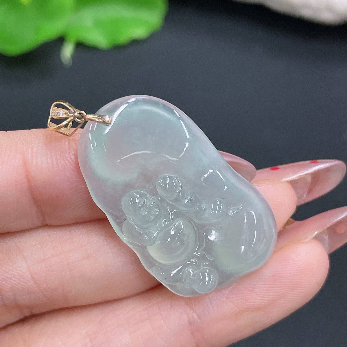 Huiliu Jadeite pendant featuring a Buddha design with bezel setting, showcasing the smooth, polished jade surface and intricate craftsmanship.