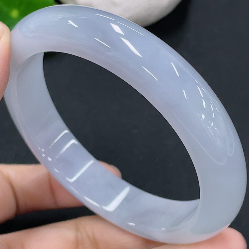 Huiliu certified jadeite round bangle showcasing smooth, polished green jade with a glossy finish on a plain background.