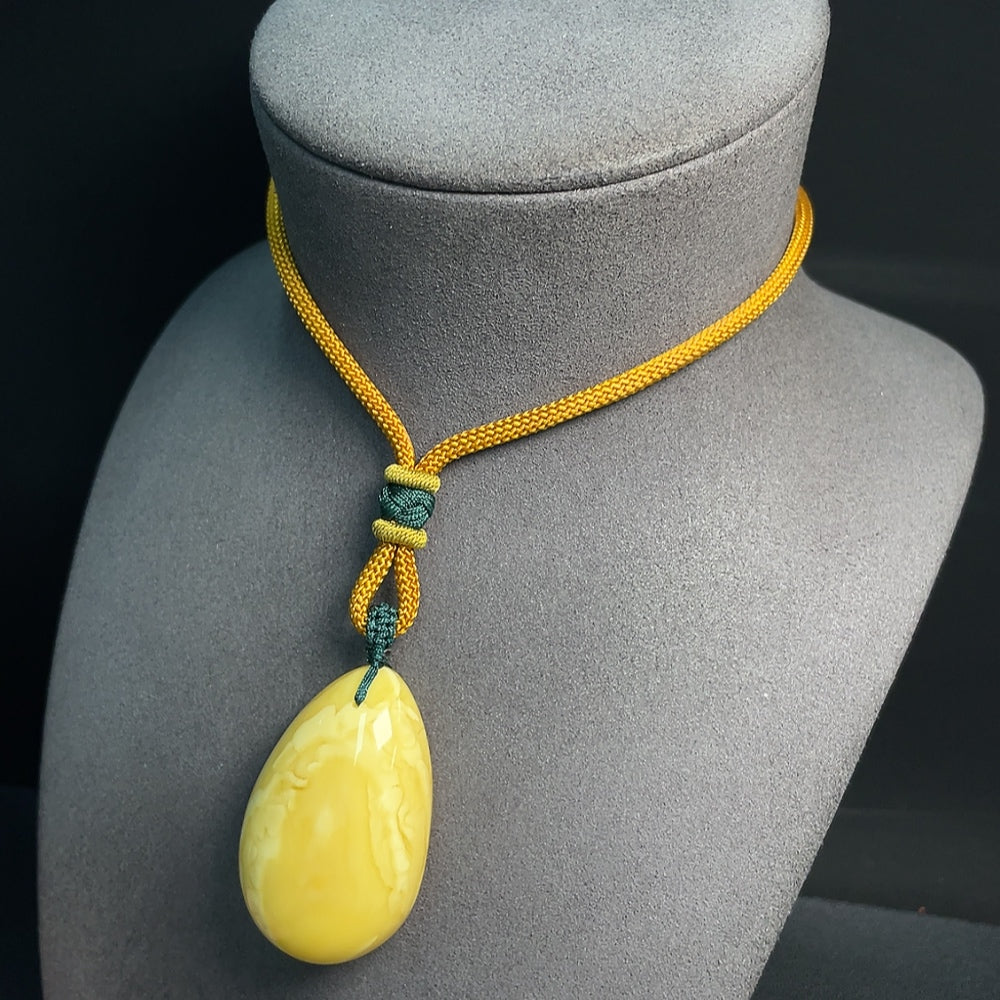 HUILIU HQ Amber beeswax pendant with rope, natural amber jewelry featuring warm honey tones and a polished finish.