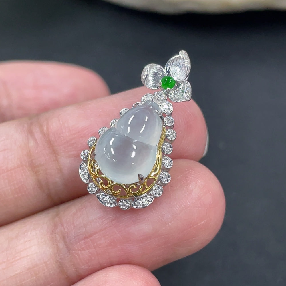Jadeite gourd pendant with 18K gold and diamond accents, featuring a delicate chain on a necklace display.