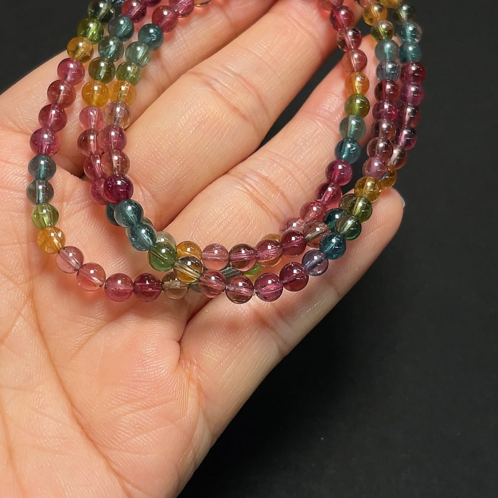 Tourmaline gemstone bead strand with visible organic matter, 4.3mm size, from HKHQ, weighing approximately 18.99g.