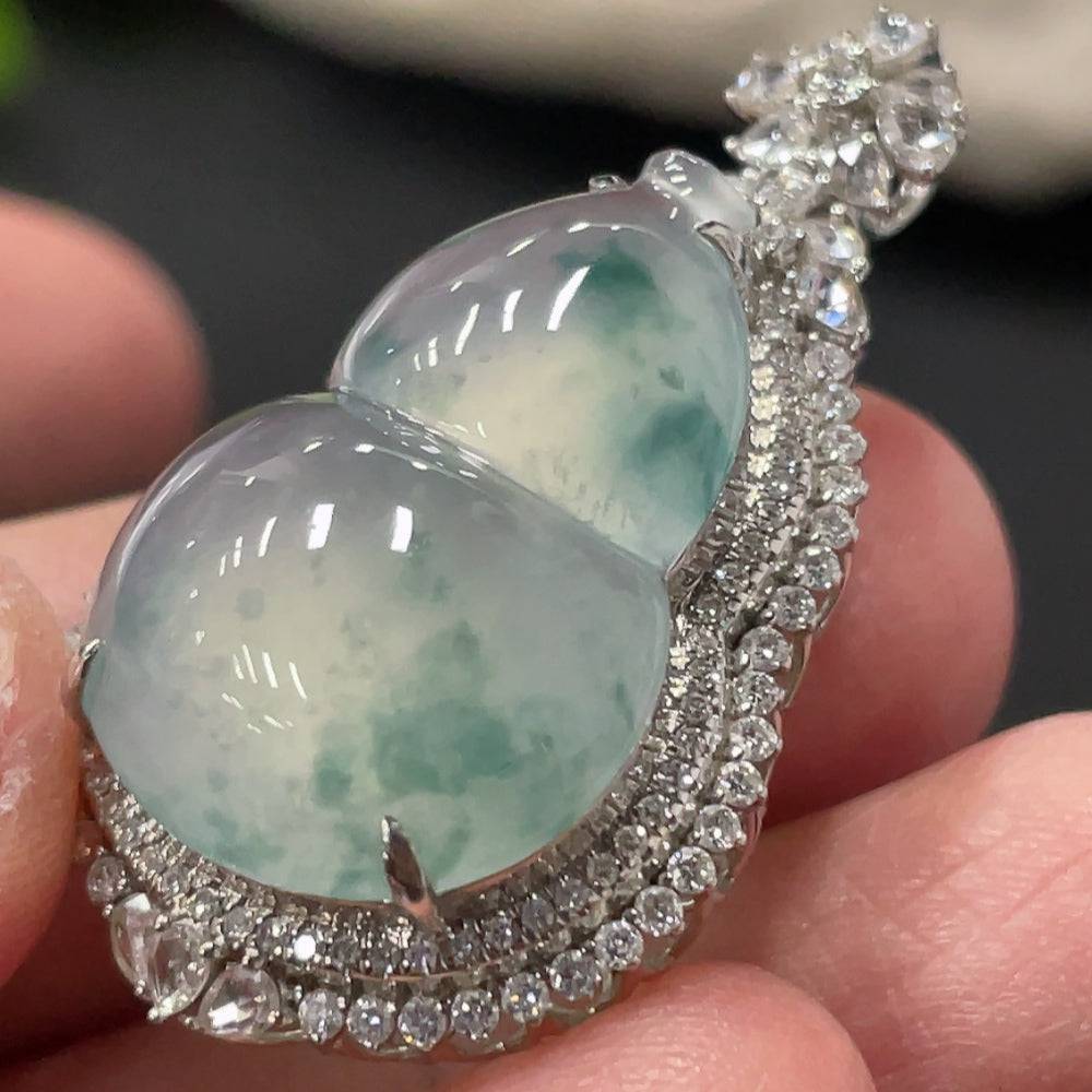 Jadeite gourd pendant with 18K gold setting and small diamond accents, showcasing smooth green jade and elegant craftsmanship.