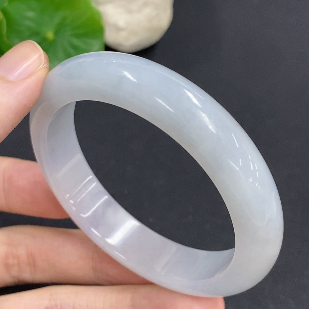 HKHQ jadeite round bangle in size 54, showcasing smooth, polished jadeite with a natural green hue and elegant round design.