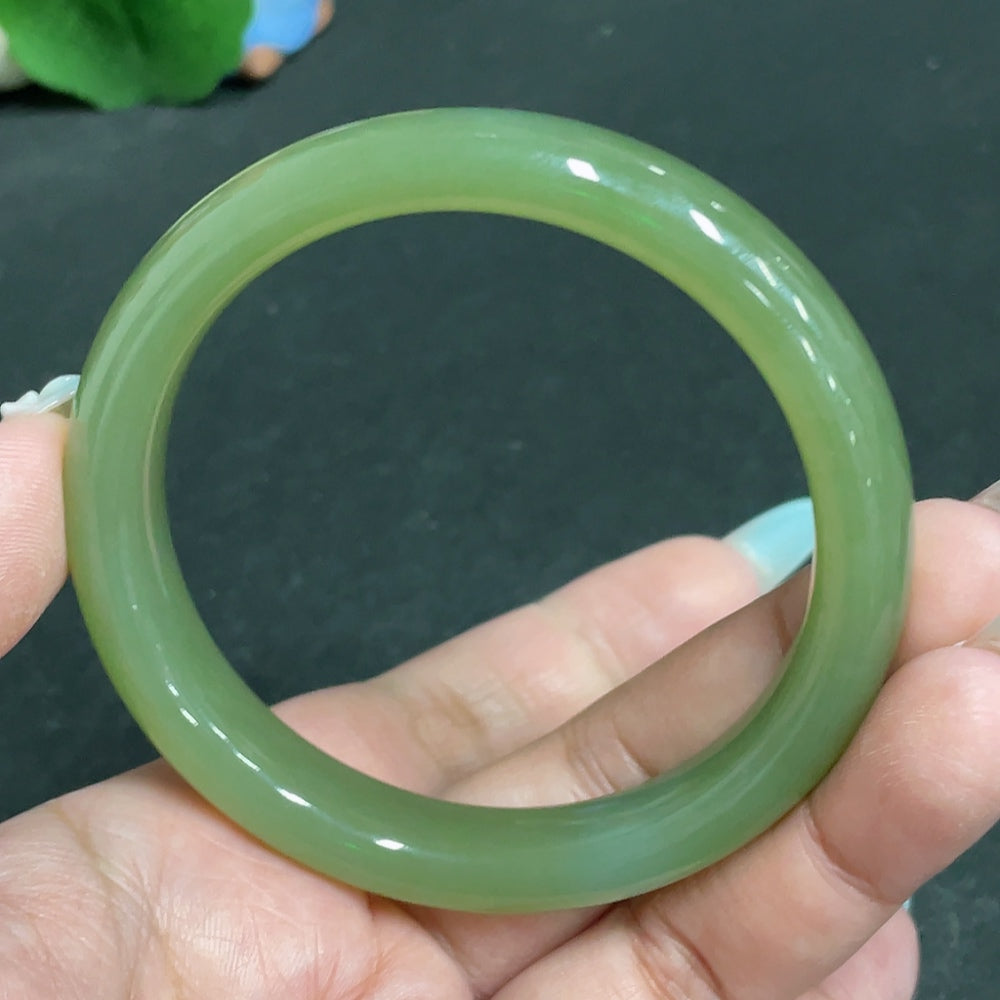 Huiliu Hetian Jade round bracelet with smooth, polished jade beads, showcasing natural green and beige tones.
