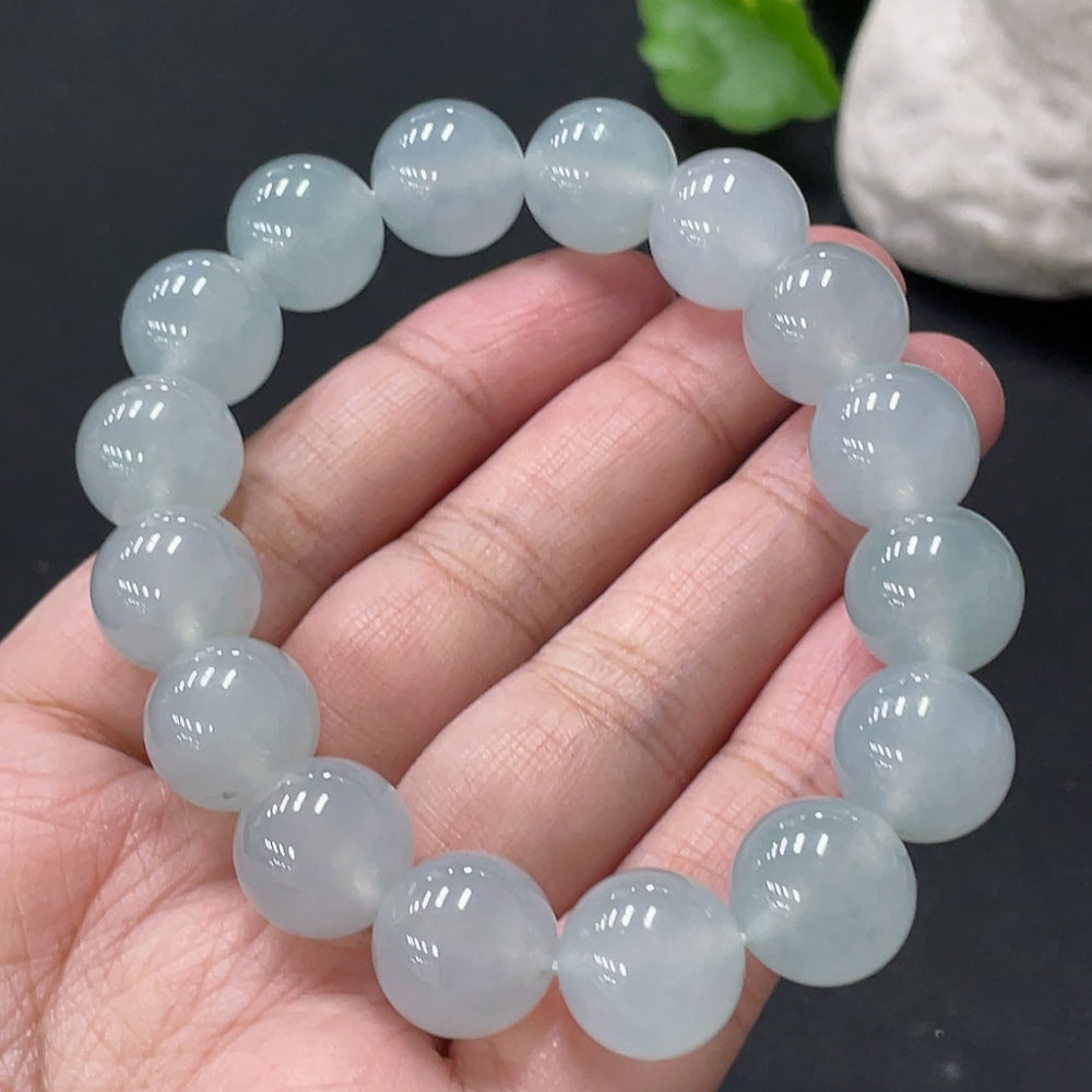 Huiliu Certified Jadeite bracelet with 13mm smooth jade beads, showcasing natural green color and polished finish.