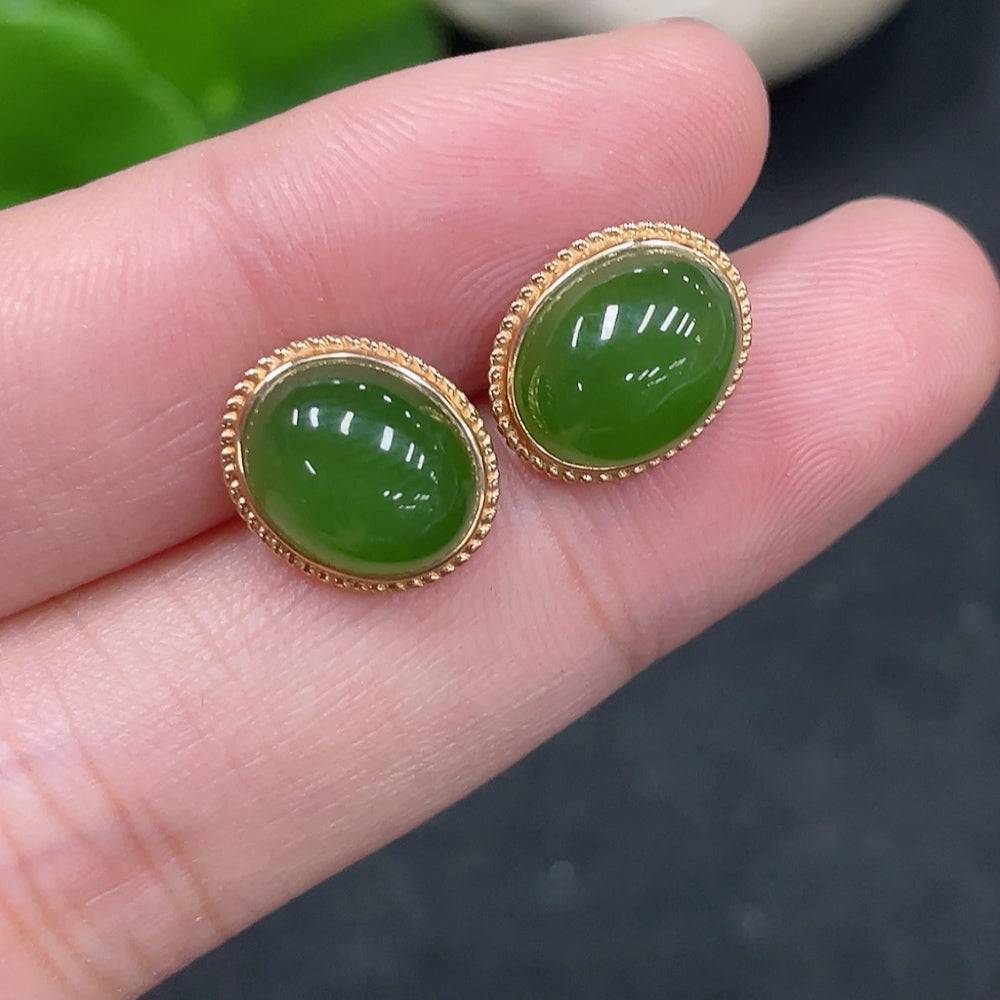 Huiliu Certified Hetian Jade cabochon earrings with gold setting, showcasing smooth green jade stones and elegant craftsmanship.