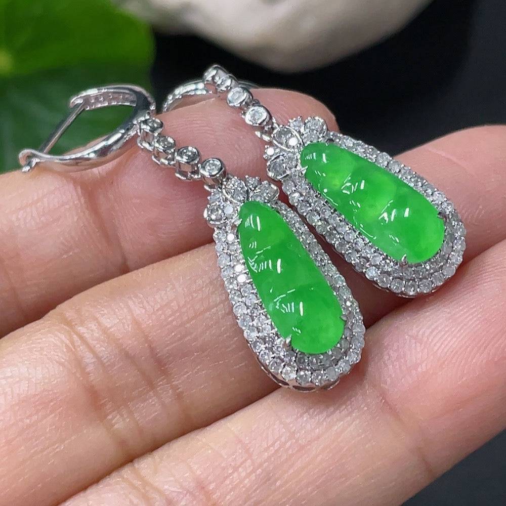 Jadeite earrings with 18k gold and diamond accents, featuring smooth jade stones and intricate gold detailing.