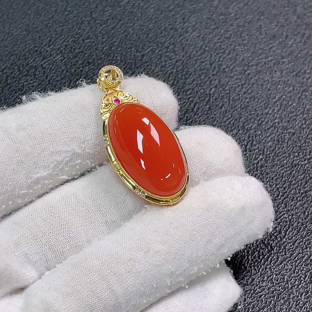 Red agate pendant with diamond accents from HUILIU HQ, showcasing a vibrant gemstone and sparkling details.