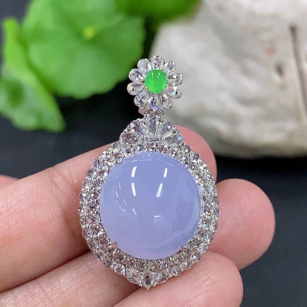 Jadeite cabochon pendant with 18K gold setting and diamond accents, featuring a polished, smooth jadeite stone on a necklace.