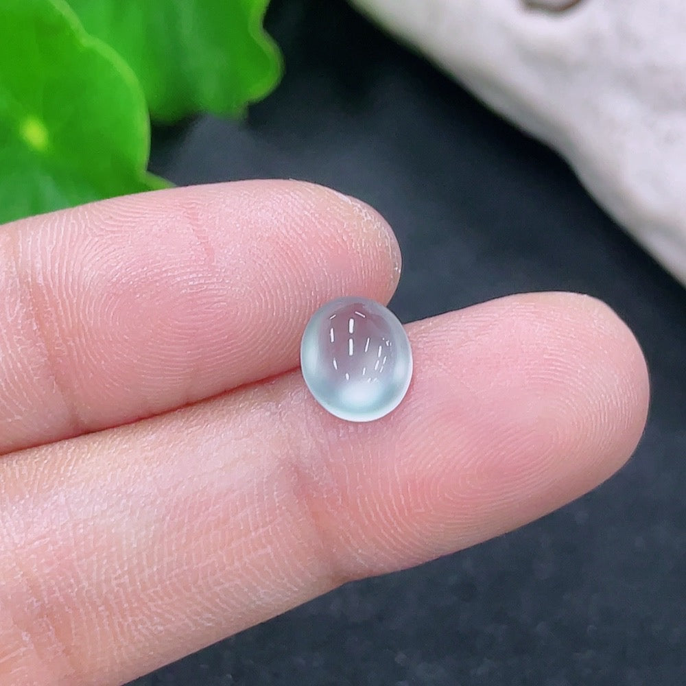 Three jadeite cabochons from HKHQ, each weighing 0.27g, showcasing smooth, polished green gemstones for jewelry making.