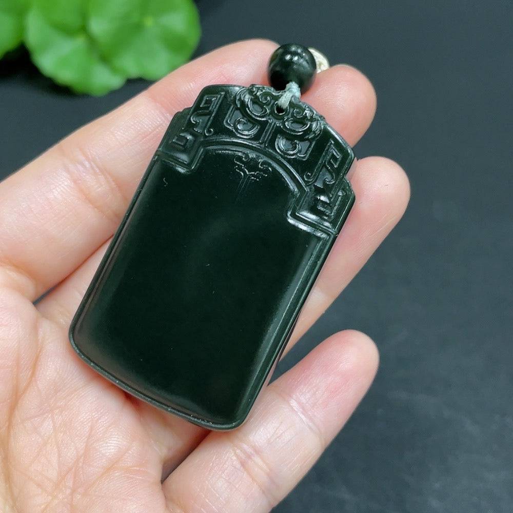 Huiliu certified Hetian jade pendant with antique plaque design and attached rope, showcasing intricate jade craftsmanship.