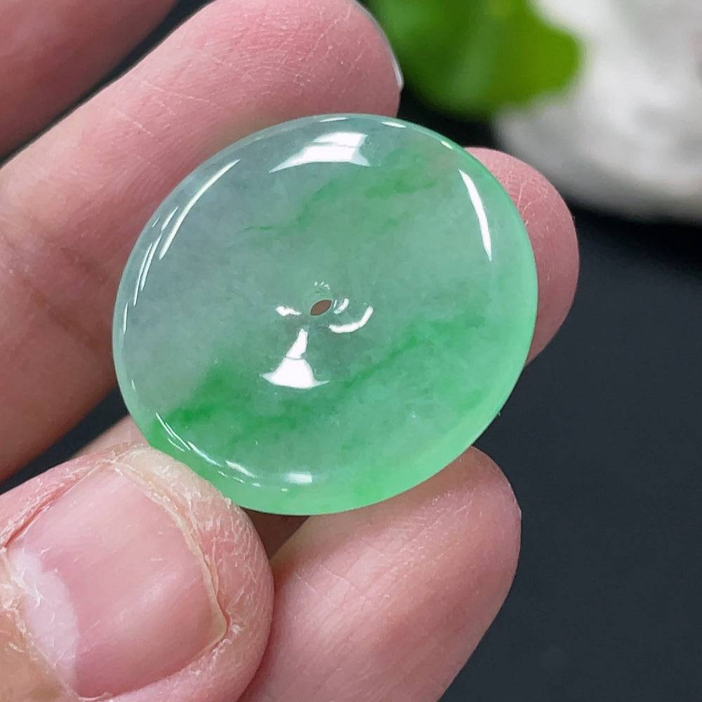 Jadeite Peace Knot pendant from HUILIU HQ showcasing a smooth, polished jade pendant with intricate knot design and a gentle green hue