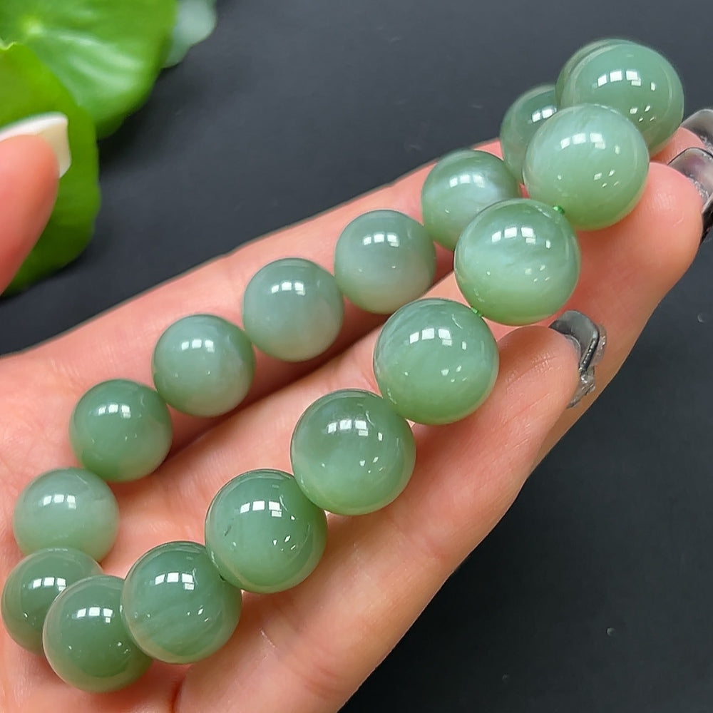 HKHQ Hetian jade bracelet with 11.8mm beads, showcasing smooth green jade stones on a white background.