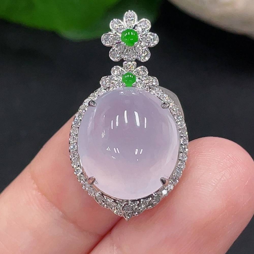 Jadeite pendant with 18K gold setting, accented with diamonds, showcasing a smooth green jade stone and elegant design.