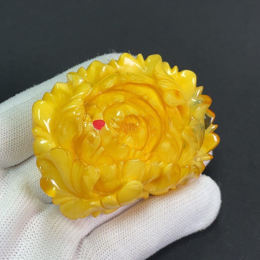 Amber beeswax pendant with partial visible repairs, weighing approximately 36.25g, crafted by HKHQ, shown with detailed surface texture.