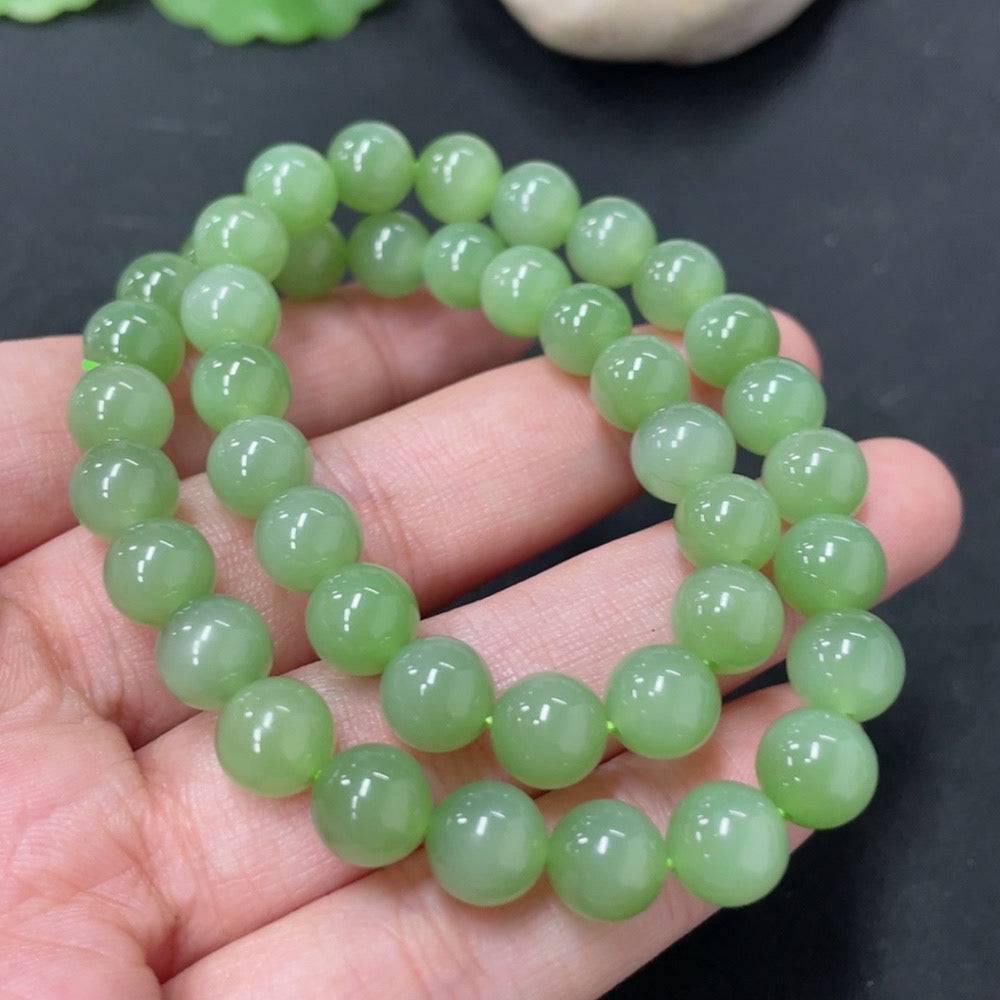 Hetian jade bead necklace with 7.6mm beads, weighing approximately 33.6g, showcasing smooth, polished green jade stones.