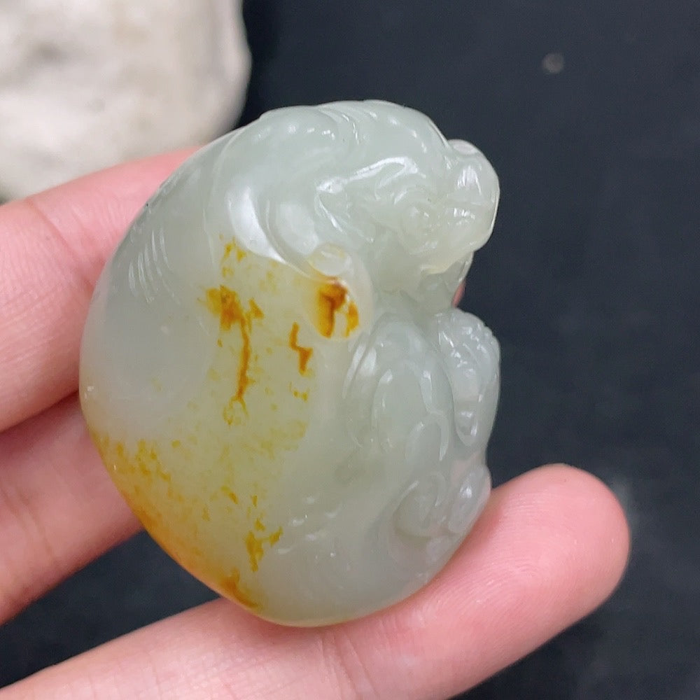Huiliu certified Hetian jade pendant featuring an auspicious beast design in undetermined skin color, showcasing intricate craftsmanship.
