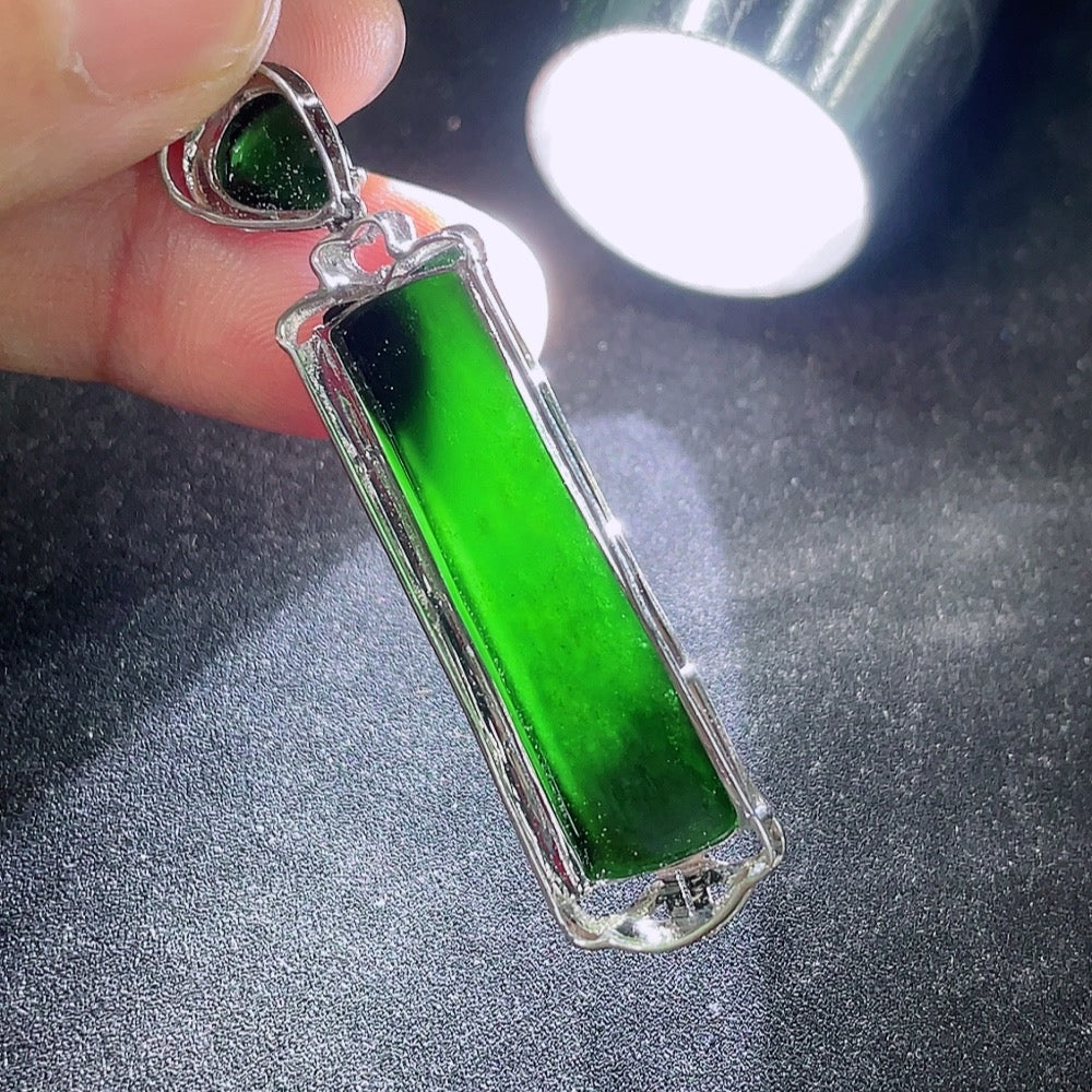 Jadeite plain pendant with 9k gold mounting, shiny green jade stone, weighing approximately 3.92g, displayed on a jewelry stand.