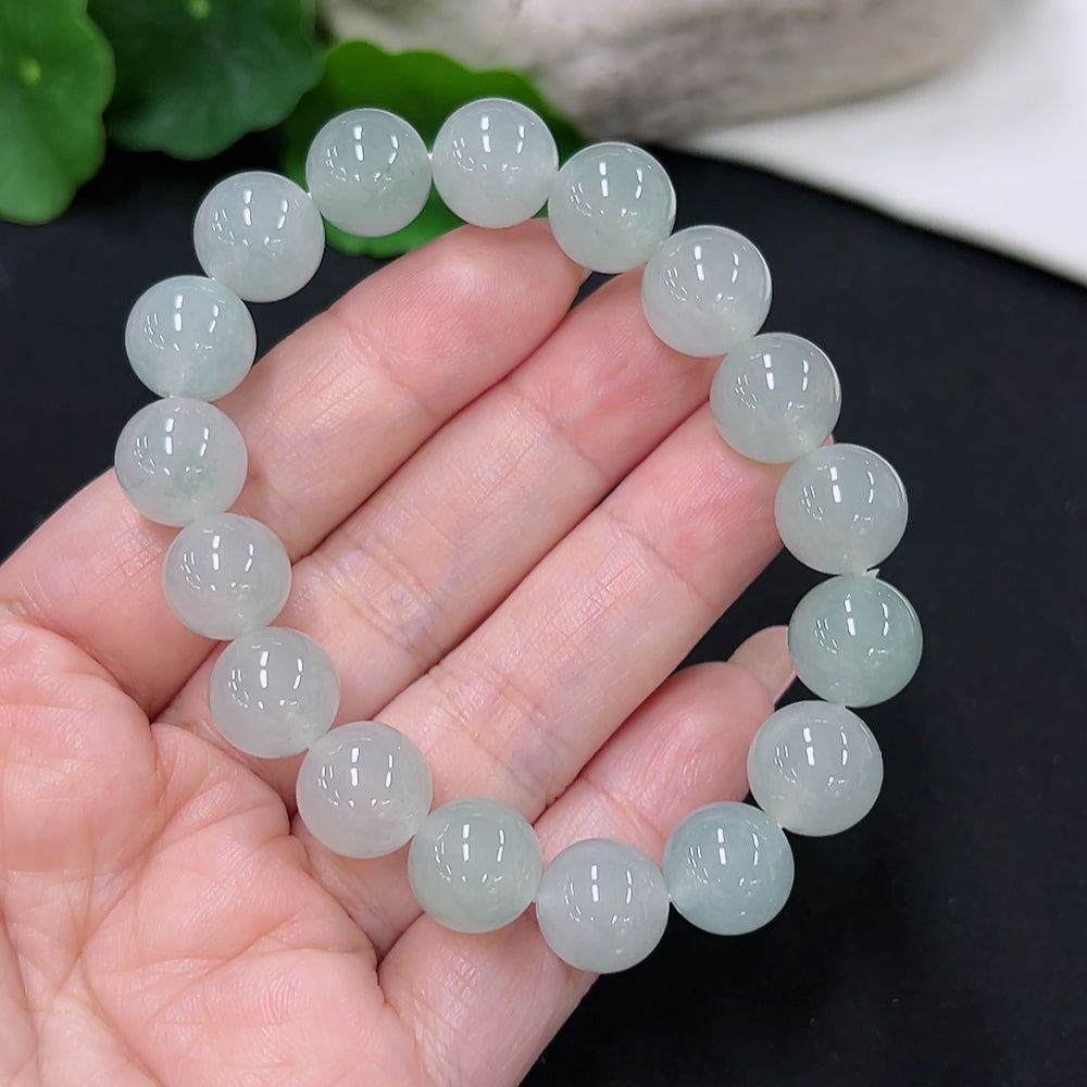 HKHQ Jadeite bracelet with 11.2mm beads, approximately 41.89g, showcasing smooth green jade stones on a white background.