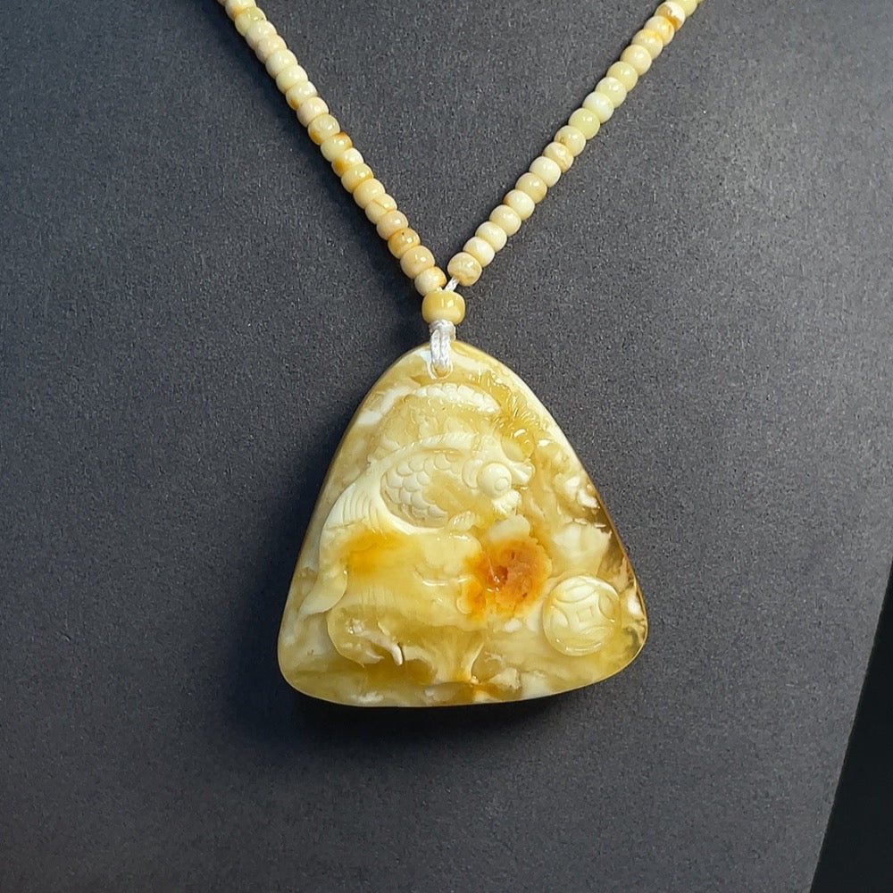 HKHQ amber beeswax pendant with colorless coating, partial repairs, and collection certificate, weighing approximately 35.77g.