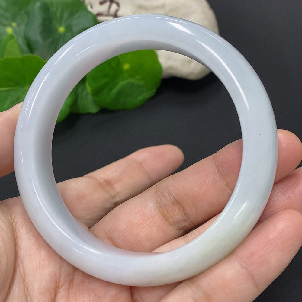 Huiliu certified jadeite round bangle featuring smooth, polished green jade with natural variations and a sleek, rounded design.