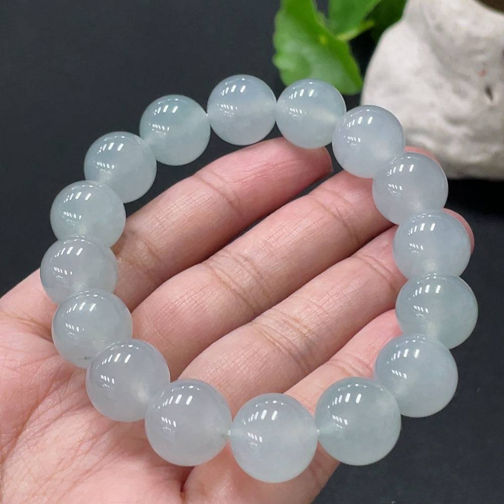 Huiliu jadeite bracelet with 13mm smooth green jade beads, certified by HUILIU HQ, displayed on a neutral background.