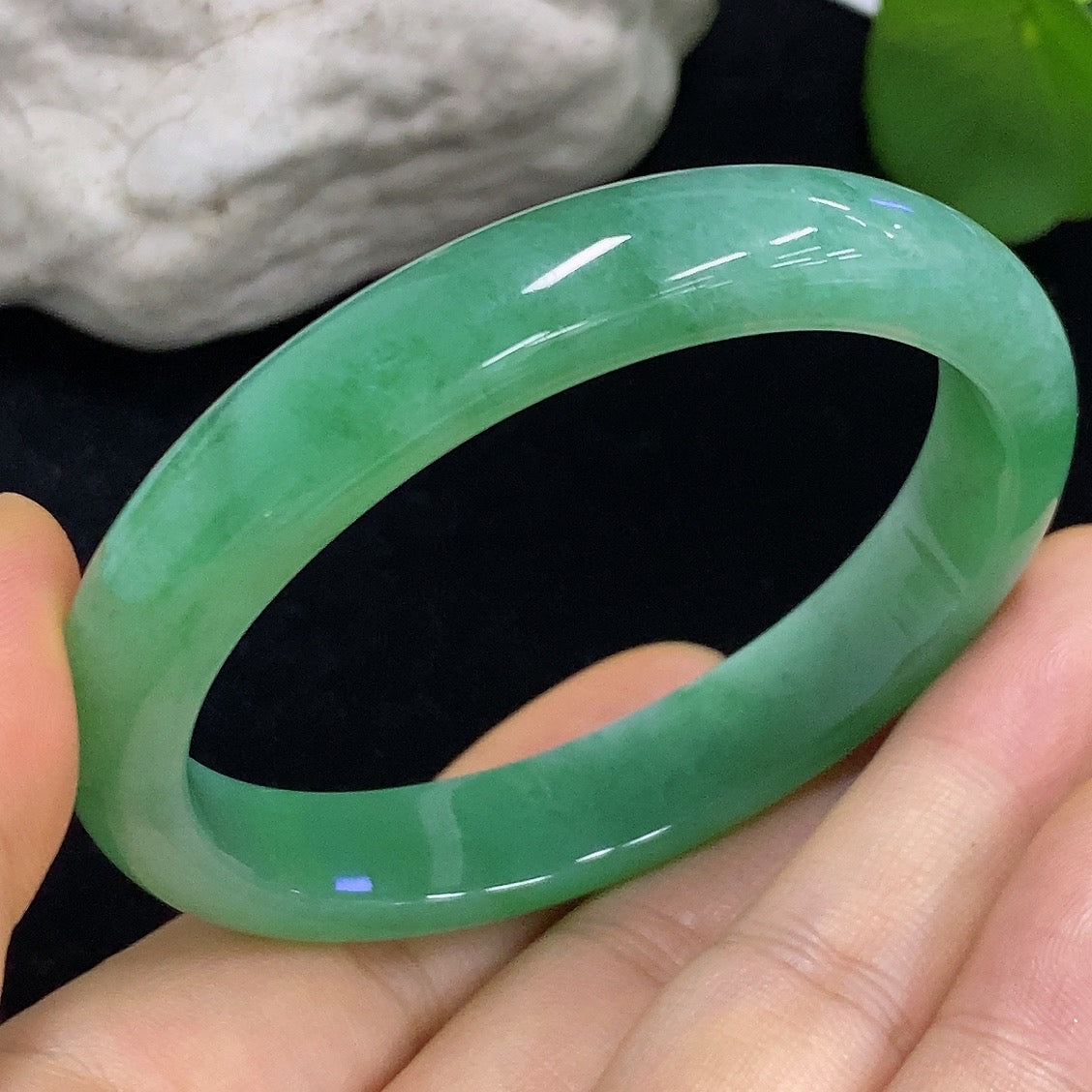 HKHQ jadeite oval bangle in size 56.2, 38.3g, showcasing smooth, polished green jadeite with a classic oval shape.