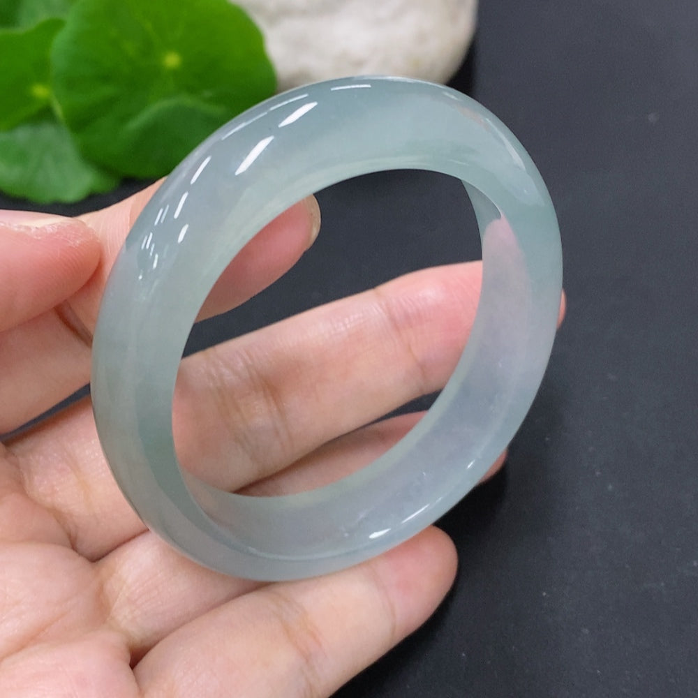 Jadeite oval bracelet featuring smooth, polished green jade stones strung together, crafted by HKHQ.