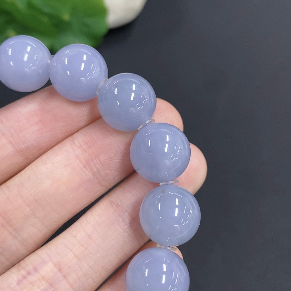 Jadeite bracelet by HKHQ featuring smooth jade beads, approximately 12.7mm in size, weighing about 56.7g, displayed on a plain background.