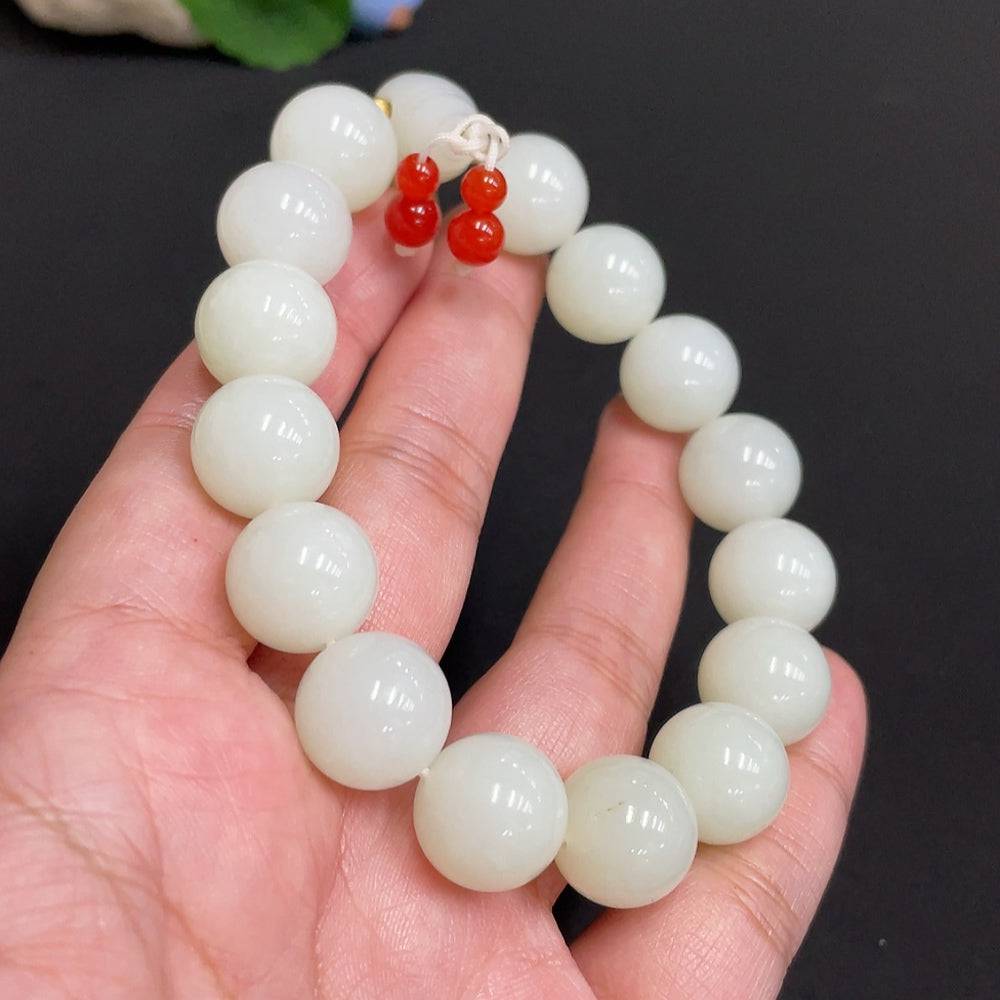 Huiliu certified Hetian jade bracelet with 13.8mm jade beads and mineral components, showcasing a polished, elegant design.