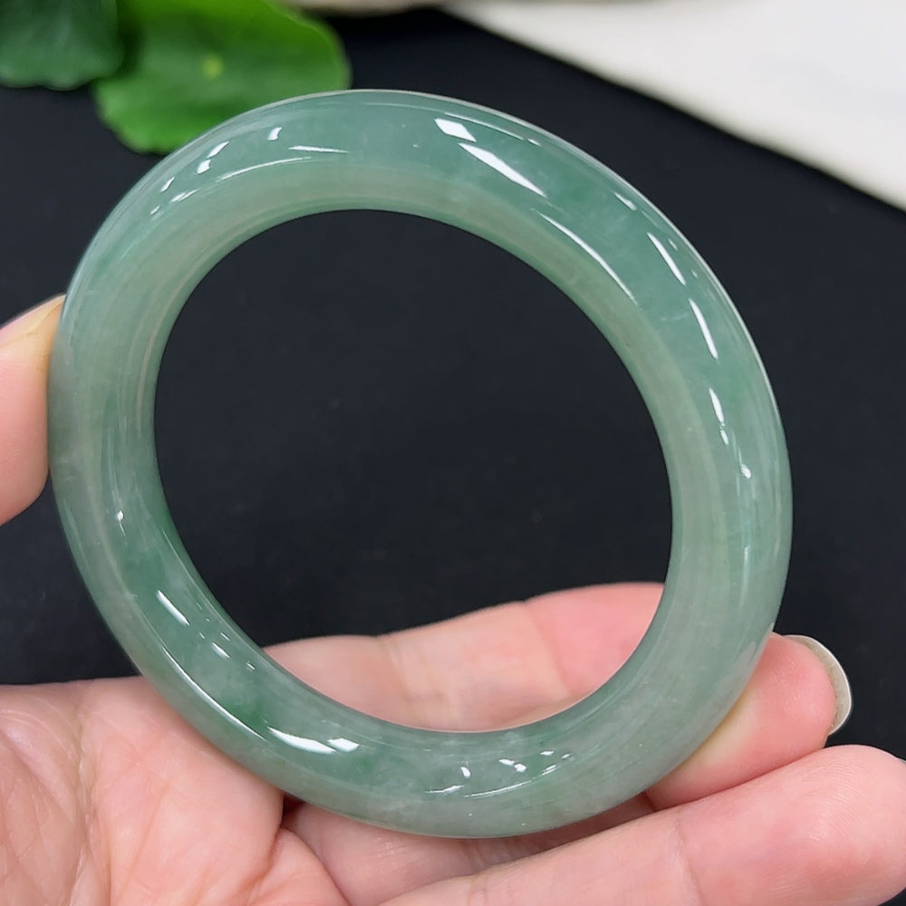 HKHQ jadeite round bangle, size 54.3, weighing approx. 58.4g, showcasing smooth, polished green jade jewelry on a clean background.