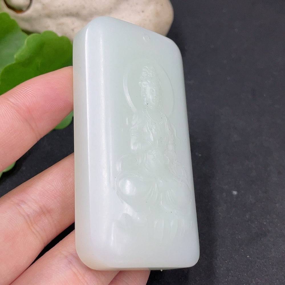 Huiliu certified Hetian jade Guanyin pendant featuring intricate carvings and smooth polished surface.