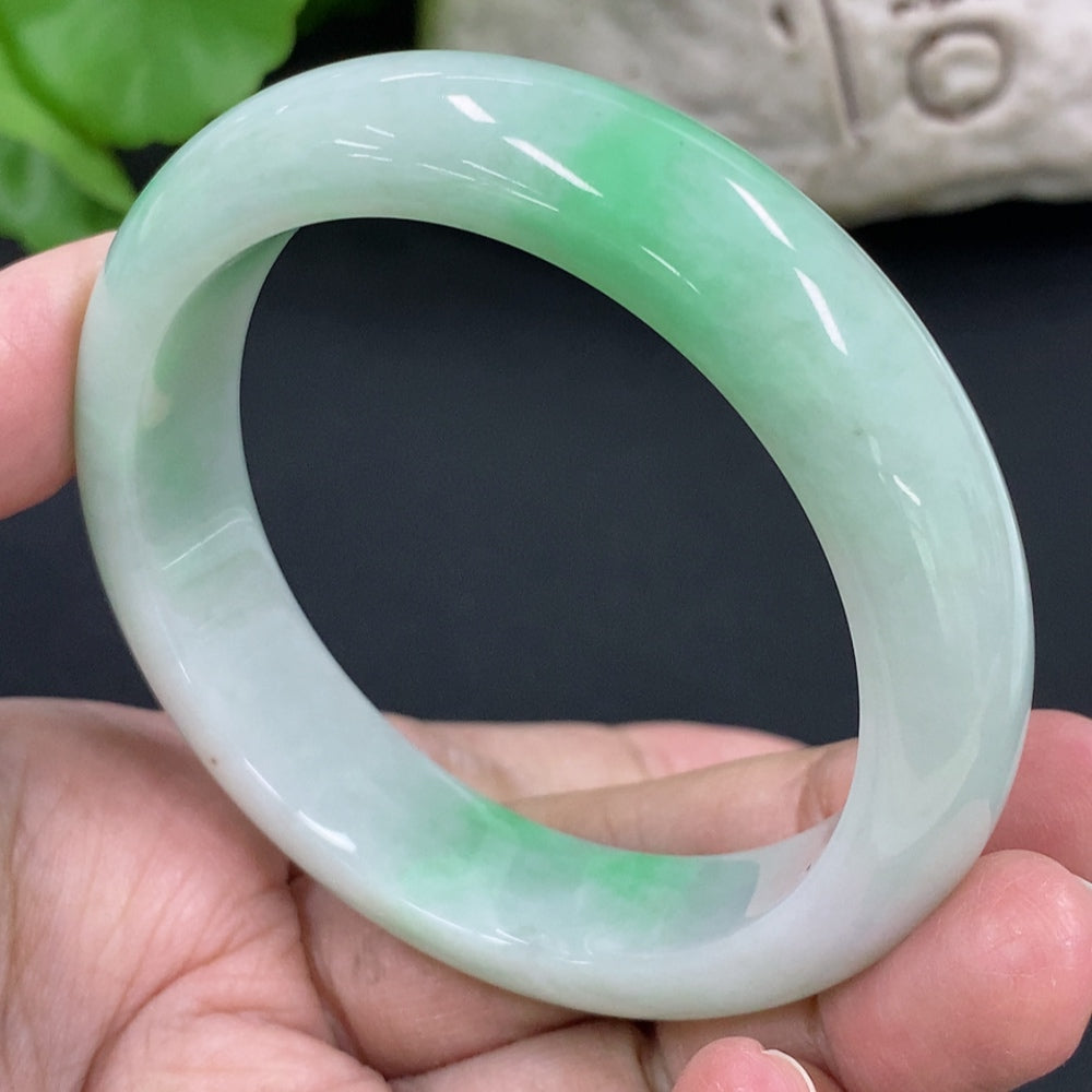 HKHQ jadeite round bangle in size 53.8 with a 56.6g weight, showcasing smooth, polished green jadeite surface and classic circular shape.