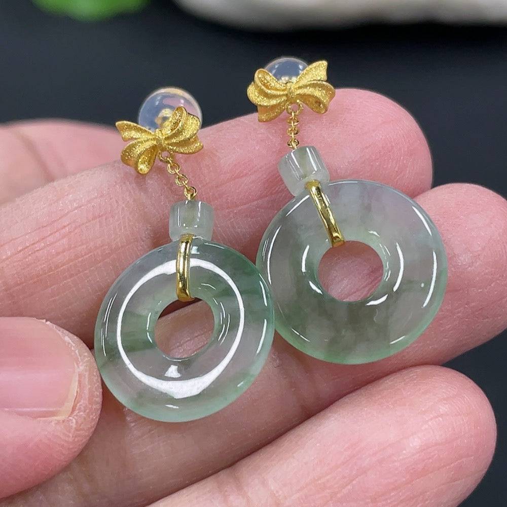 Pair of HUILIU HQ jadeite donut inlaid earrings showing smooth jade surface and intricate inlay details, excluding ear stoppers.