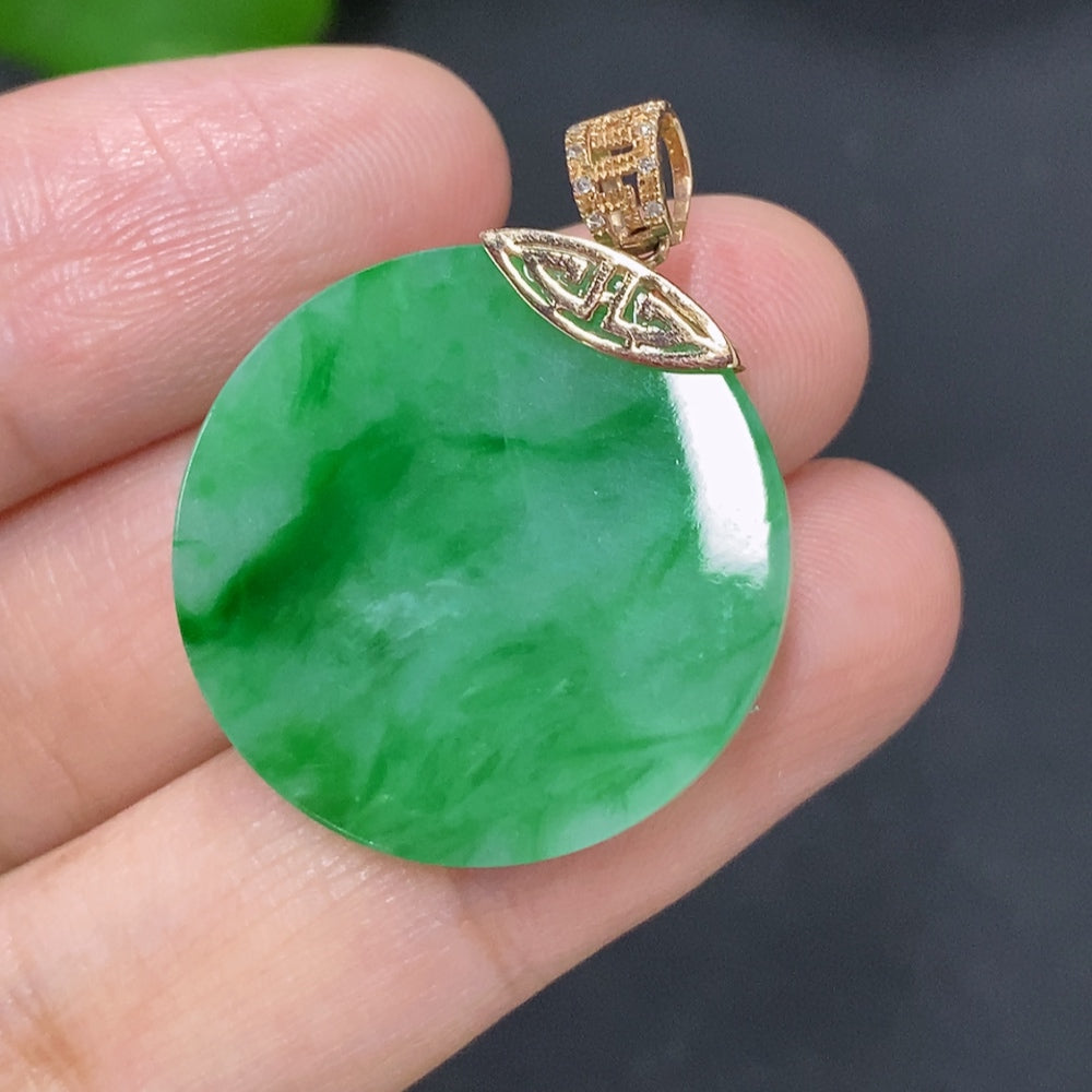 Jadeite pendant with 18K gold bail, set with diamonds, showcasing a smooth, polished jade gemstone on a delicate chain.