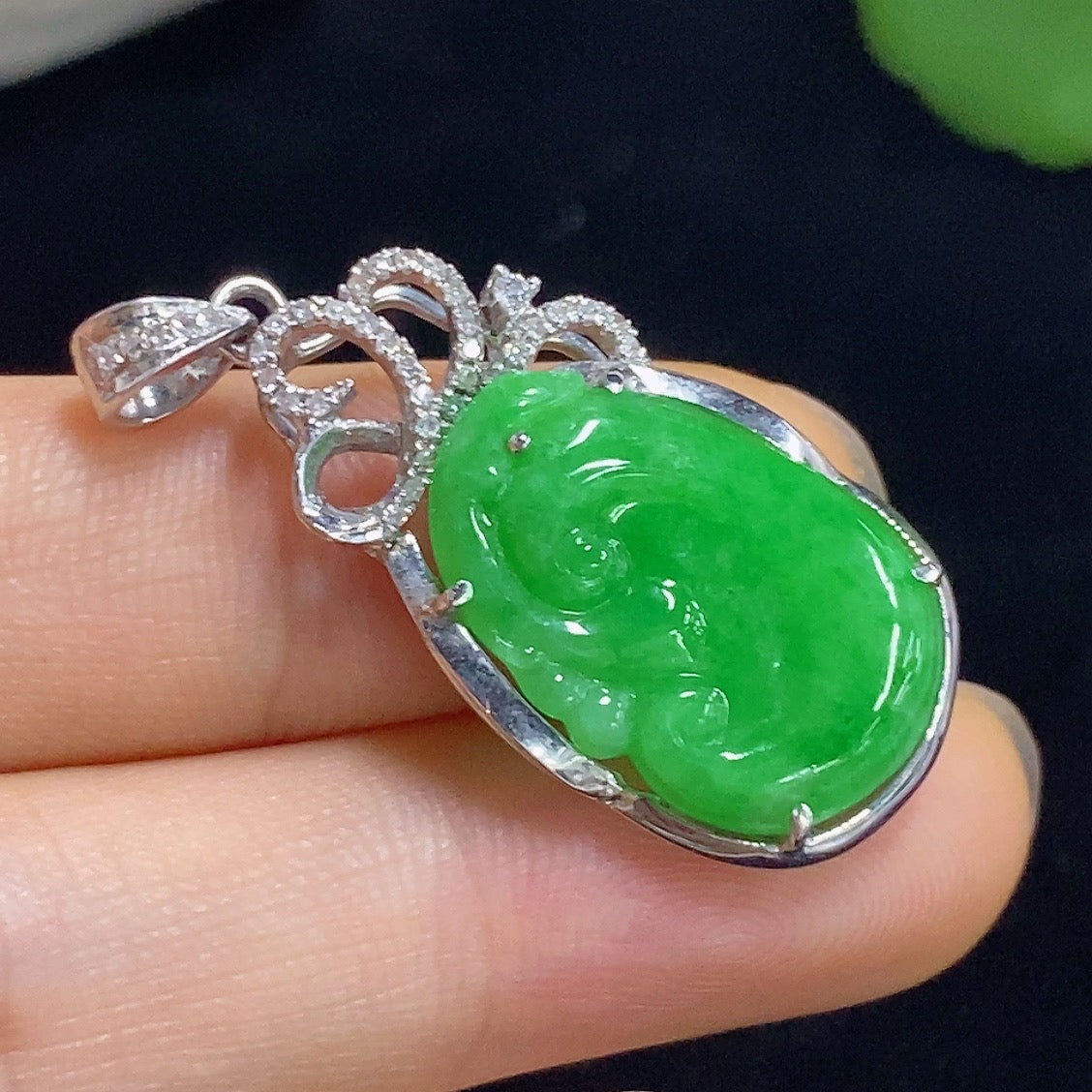Jadeite Ruyi pendant with gold inlay and diamond accents, featuring a gold content of 70%, displayed on a necklace.