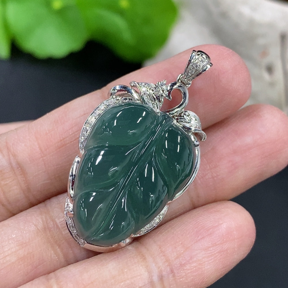 Jadeite leaf inlay pendant with 18K gold and diamond accents, elegant necklace featuring intricate design and sparkling details.