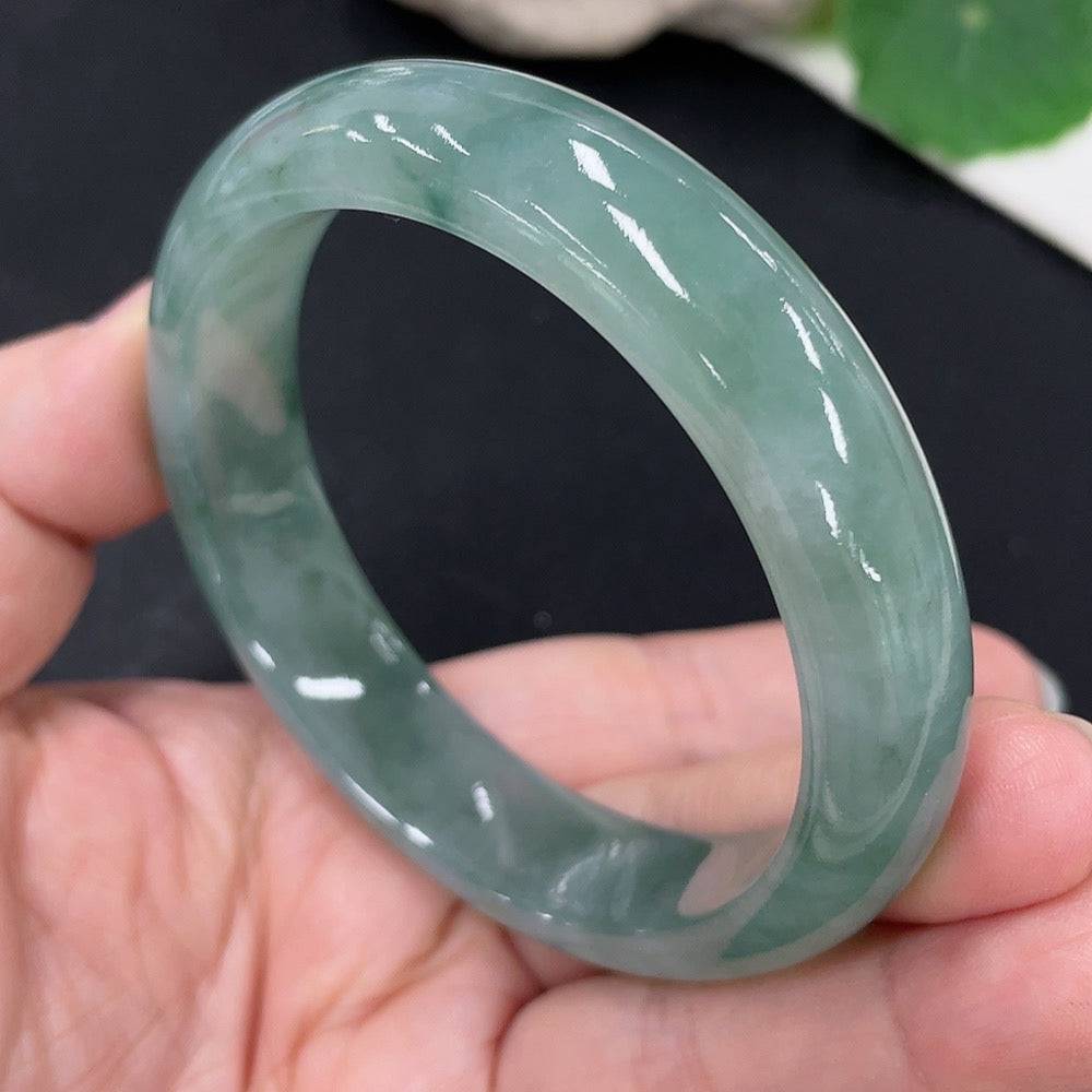 Huiliu jadeite round bracelet featuring polished green jade beads, certified by Huiliu HQ, on a neutral background.