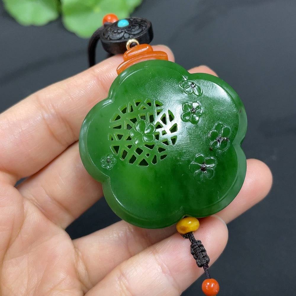 Hetian jade jasper pendant featuring floral and wealth motifs, crafted by HUILIU HQ, with intricate blooming flower design.
