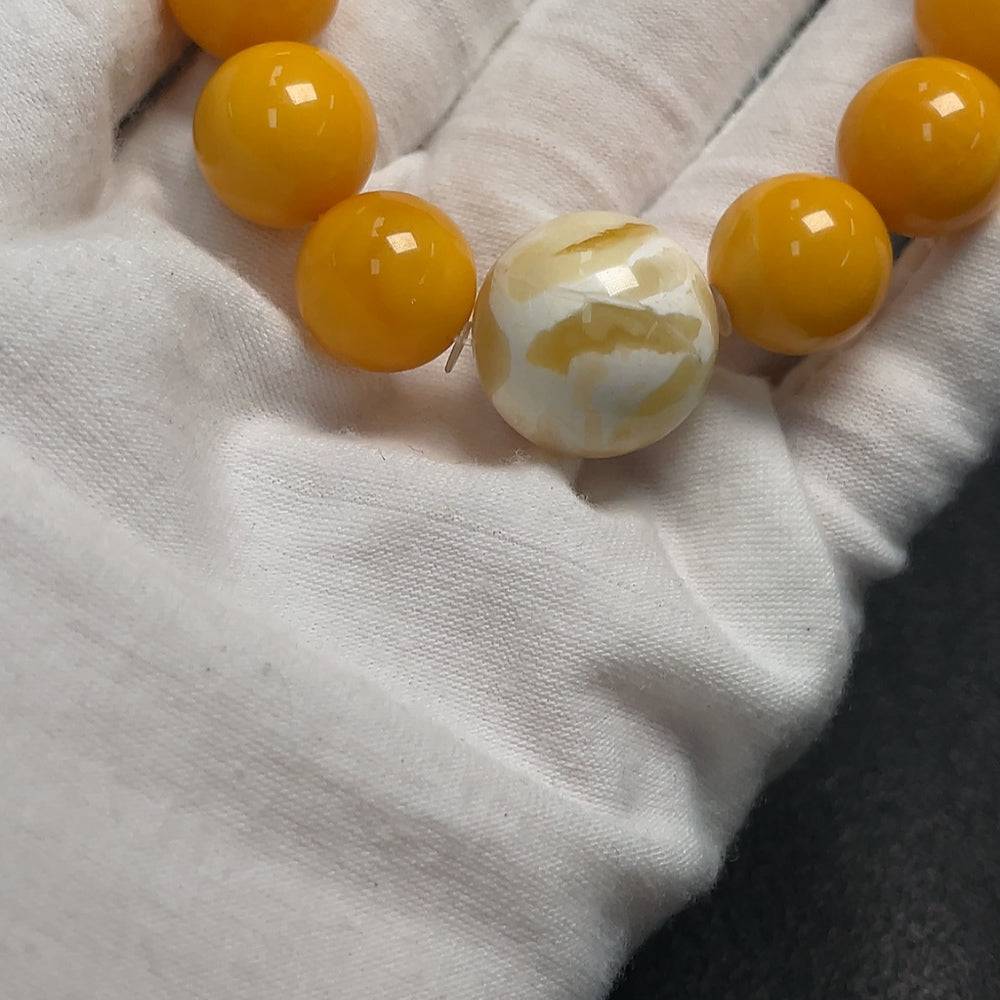 Huiliu certified amber beeswax bracelet with 18.4mm beads, showcasing warm amber tones and smooth, polished surface.
