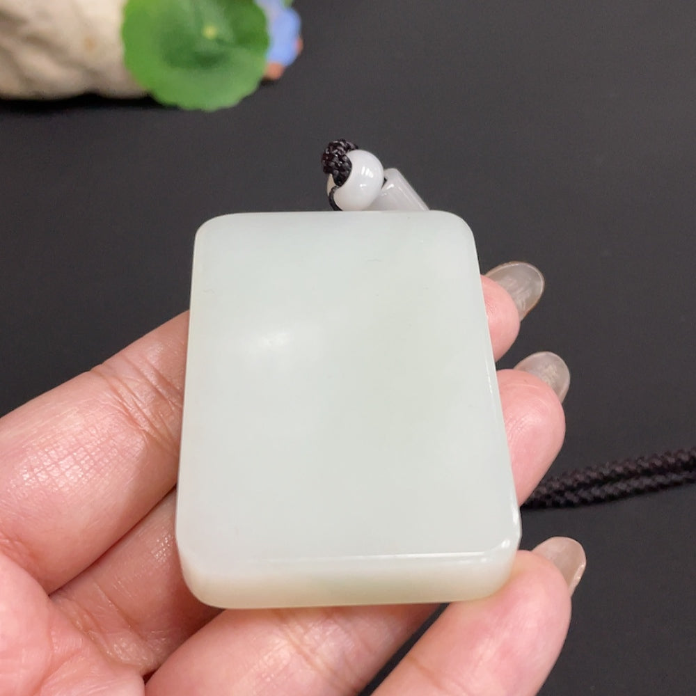 Huiliu certified Hetian jade pendant with plain design, showcasing smooth, polished green jade stone on a neutral background.