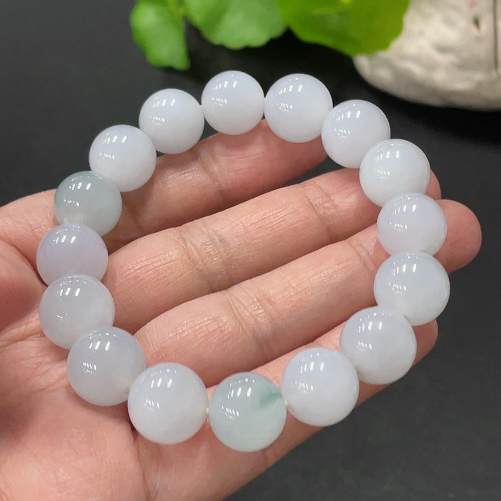 Huiliu certified jadeite bracelet, 12.4mm wide, featuring smooth, polished jade stones on a delicate string.