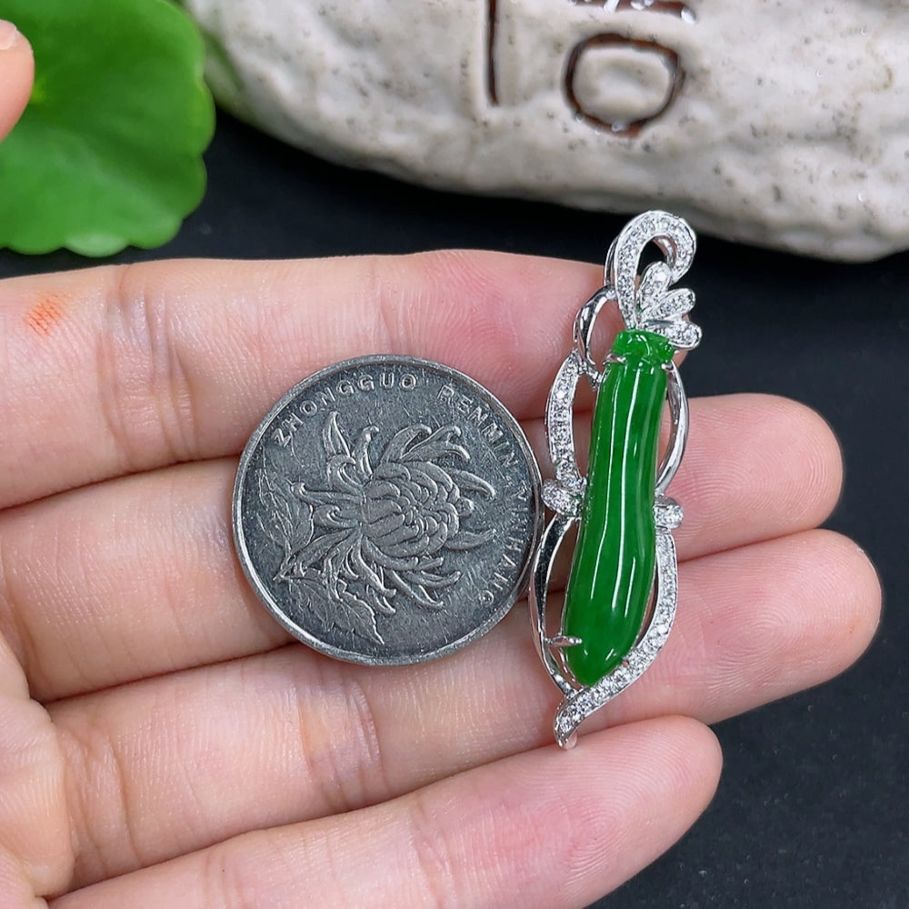 Jadeite pendant necklace set with 18K gold and diamonds, featuring a lush green jadeite stone and intricate gold design.