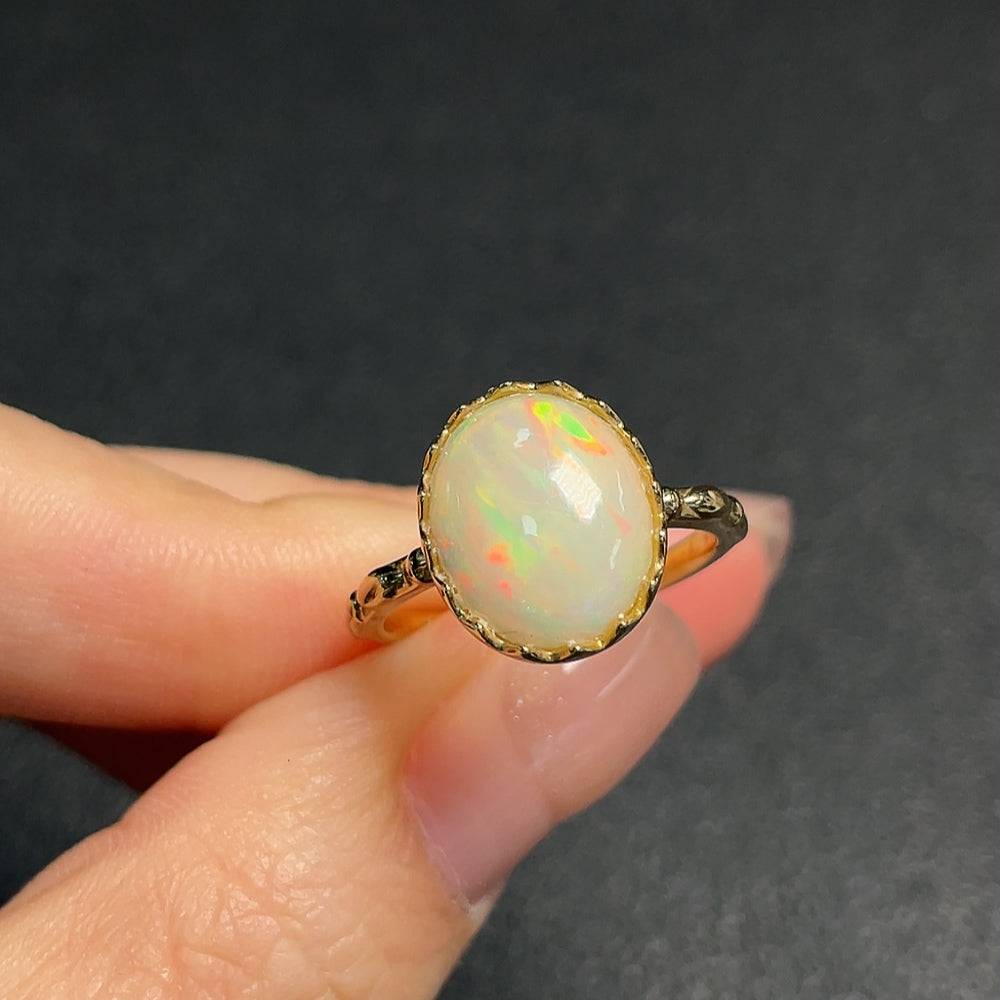 Huiliu certified opal gemstone ring with 37% gold content, featuring a vibrant, polished opal stone set in a sleek band.