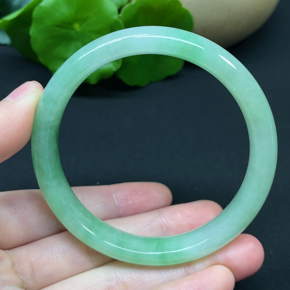 HKHQ jadeite round bangle in size 54.7 with a polished surface, weighing 37.95g, showcasing smooth, vibrant green jadeite.