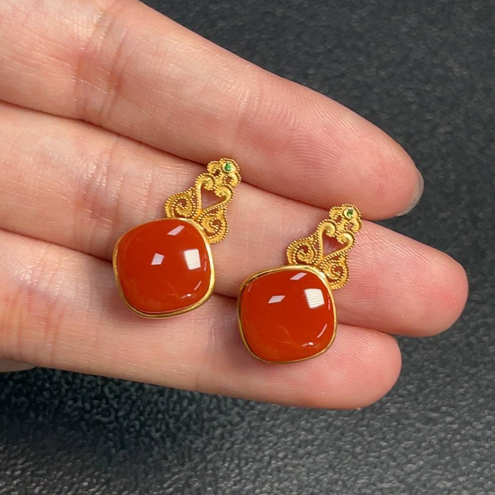 Red Agate gemstone earrings with diamond accents, featuring organic matter and possible non-natural gemstones, by HUILIU HQ.